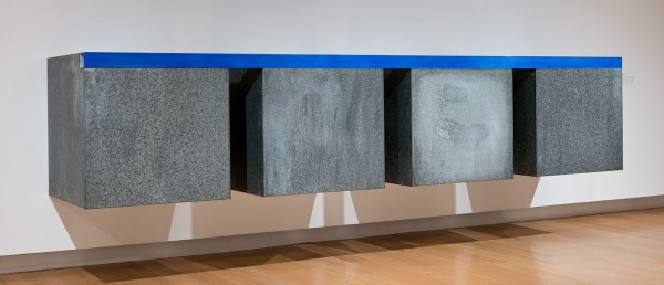Donald Judd sculpture of four iron and aluminum boxes topped with a blue stripe