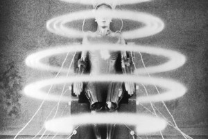 black and white image still of an old robot with multiple halos running down its body
