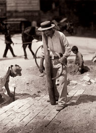 Atget's photograph of several men paving a street in Paris