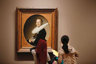 A family viewing a Dutch 16th century painting